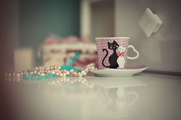 cup of coffe and colored jewelry prepared for bride