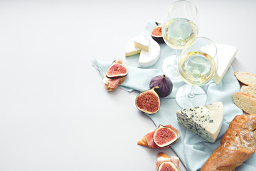 wine and snacks on grey table