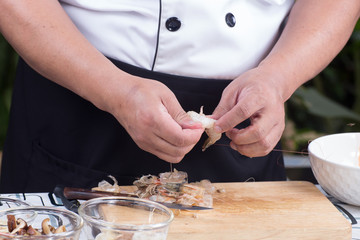 Chef peeling shrimp before cooking