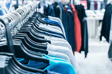 Different clothes on hangers close up