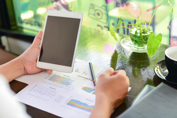 Woman typing text message on smart phone in a cafe. Cropped imag