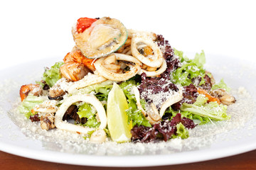 Warm salad with seafood, boiled eggs, lemon, red caviar and raw