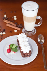 brownie with cream cheese on a dark wood background
