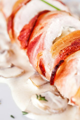 Stuffed turkey rolls with ham and spring onions in creamy sauce