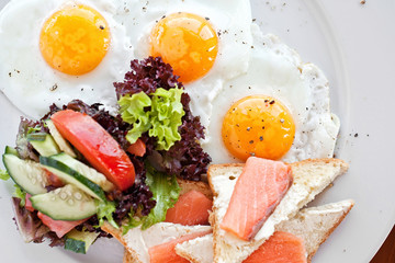 American breakfast with fried eggs, salmon, toasts,Fish fry.