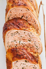 Stuffed turkey rolls with ham and spring onions in creamy sauce