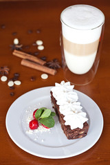 brownie with cream cheese on a dark wood background