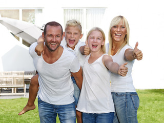 Parents giving piggyback ride to children 
