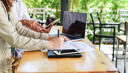 female hands over business document with graph and chart to cofe