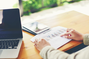 Business people  discussing and pointing to diagram graphs