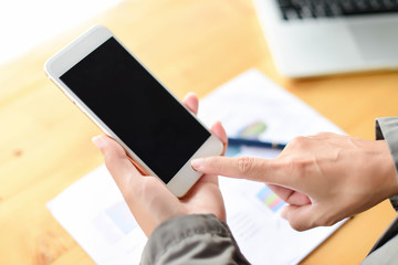 Young businesswoman hard at work at her desk writing notes on a