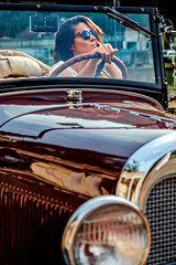 Girl driving classic convertible
