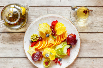 fruit salad and tea on a wooden table
