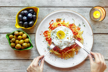 Spanish dish with fries and eggs in a cafe