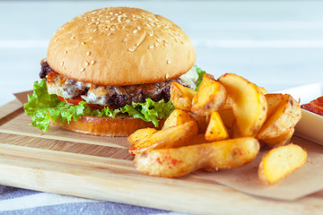 burger and french fries on wooden table