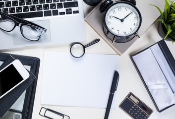 White office desk table with a lot of things on it. Top view