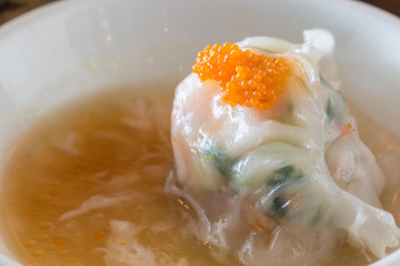 Streamed crab meat and vegetables dumpling with white egg sauce.