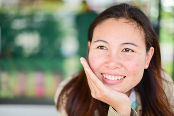 Young beautiful woman looking happy and smiling at coffee shop.