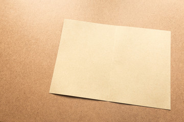 Brown paper note on business wood desk with copy space.