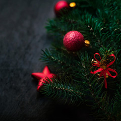 ..Black background with pine and Christmas toys. New Year Card w