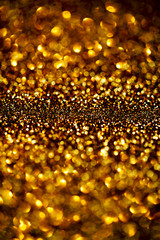 ..Dark Gold Festive blur background. Abstract night twinkled bri
