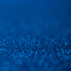 Abstract dark blue glitter bokeh holiday background. Winter xmas holidays. Christmas.