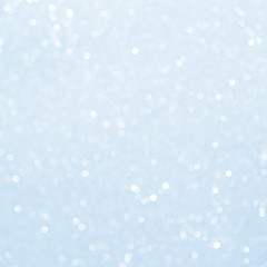 Unfocused abstract light blue glitter bokeh holiday background. Winter xmas holidays. Christmas.