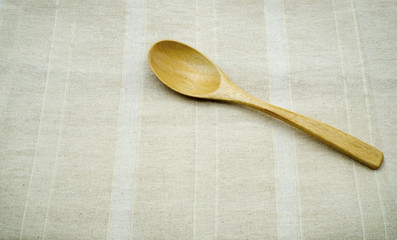 Wooden spoons on burlap background