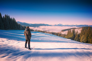 Hiker in a Carpathian winter mountain valley