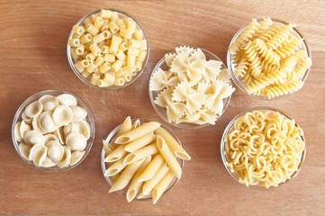 Various types of dry pasta of different shapes 