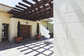 Wedding dress hanging outside of the luxury villa
