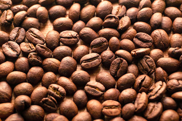 Close up roasted coffee beans on wood background