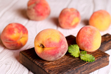 fresh peaches on wooden table