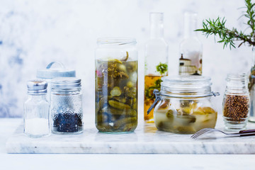 Cucumber marinated glass jar with pepper and garlic.