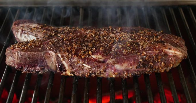 Cooking barbecue steak on the hot grill