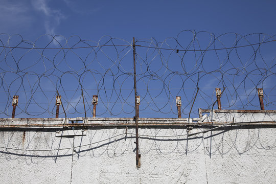 The wall with metal barbed fence