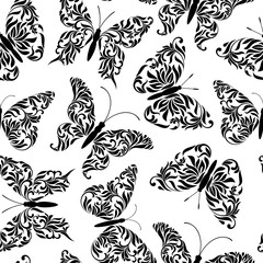 Seamless pattern with butterflies created from abstract floral tracery on a white background