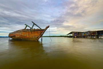 Fishing boat wreckage at  water village in Kuala Penyu, Malaysia