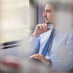 Picture of handsome businessman using commuter rail