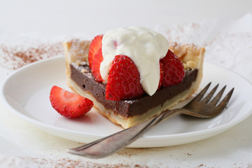 Slice of summer tart with strawberry and cream