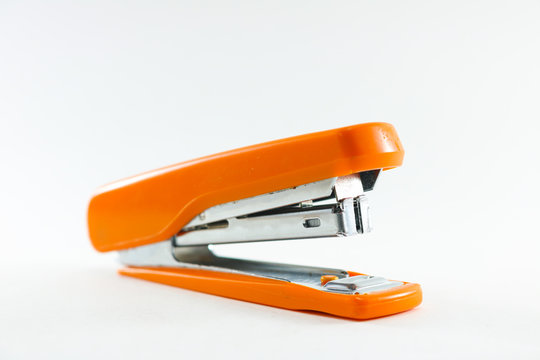 Orange stapler on white background isolated.