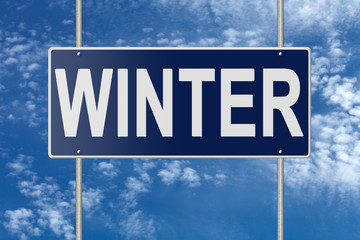 Signpost on blue nameplate on sky background