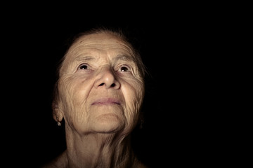 Portrait of elderly woman. Dreaminess. Toned