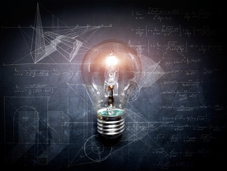 light bulb on blackboard idea concept - background