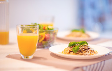 Fresh spaghetti with creamy mushroom sauce and basil leaf