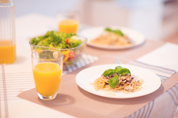 Fresh spaghetti with creamy mushroom sauce and basil leaf