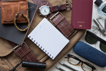Flat lay, top view, men's accessories and essential travel items on white rustic wooden background