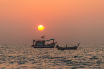 Blurred background image of sunset time and fishing boats in Kalim beach in Phuket Thailand, This image suits nicely for text backgrounds, website backgrounds, or anything else.