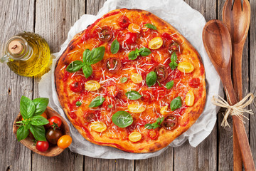 Pizza with tomatoes, mozzarella and basil