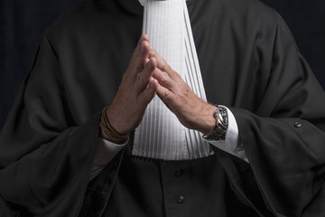 Lawyer in gown with jabot hands close up judge